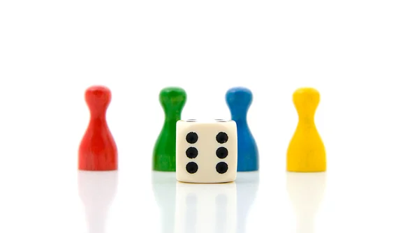 Four colorful pawns with white dice — Stock Photo, Image