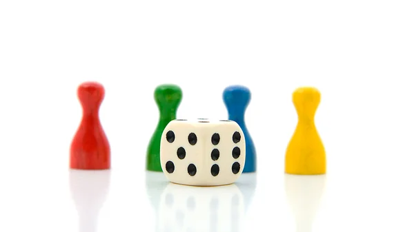 Four colorful pawns with white dice — Stock Photo, Image