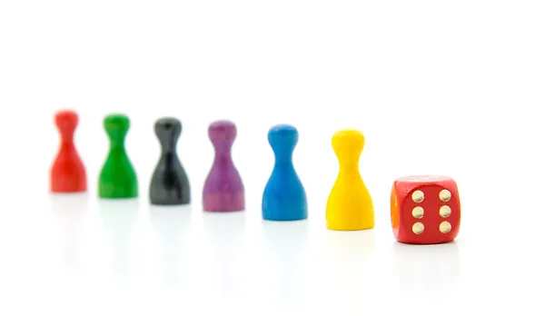 Six colorful pawns with red dice — Stock Photo, Image