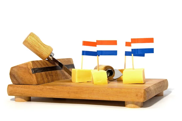 Cheese cubes on wooden board — Stock Photo, Image