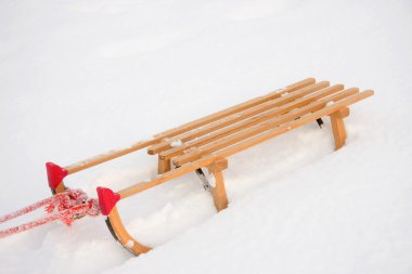 Wooden sledge in the snow clipart