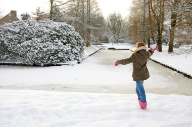 Girl is throwing snow ball clipart