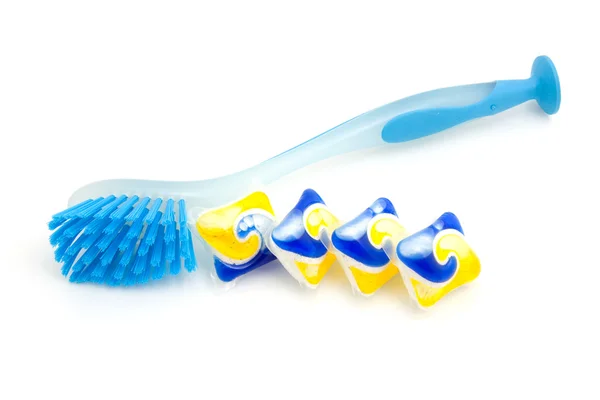 Azul escova de lavar louça e comprimidos — Fotografia de Stock