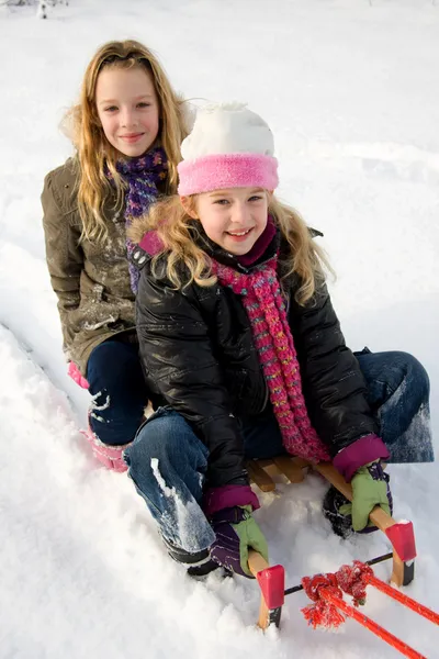 Two girls on a sled — Stock Photo, Image