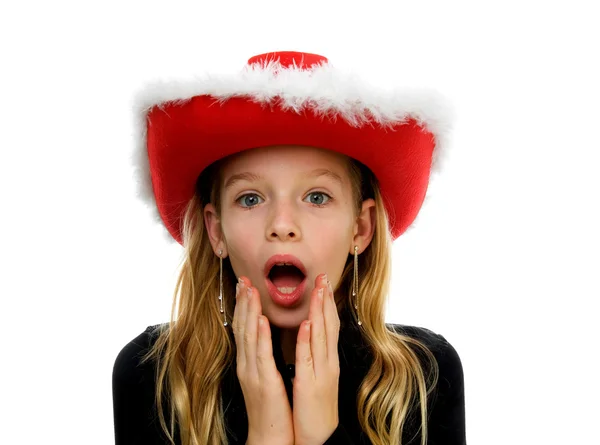Girl with christmas hat lookes amazed — Stock Photo, Image