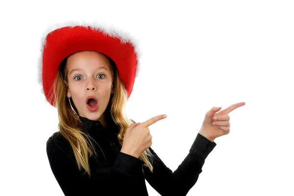 Girl with christmas hat looks amazed — Stock Photo, Image