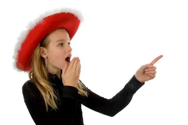 Menina com chapéu de Natal parece surpreso — Fotografia de Stock