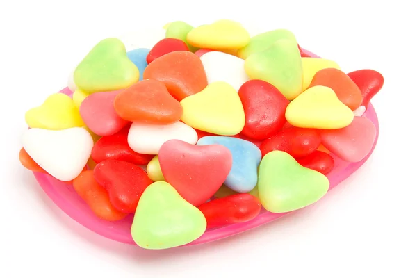 Pink plate with colorful candy — Stock Photo, Image