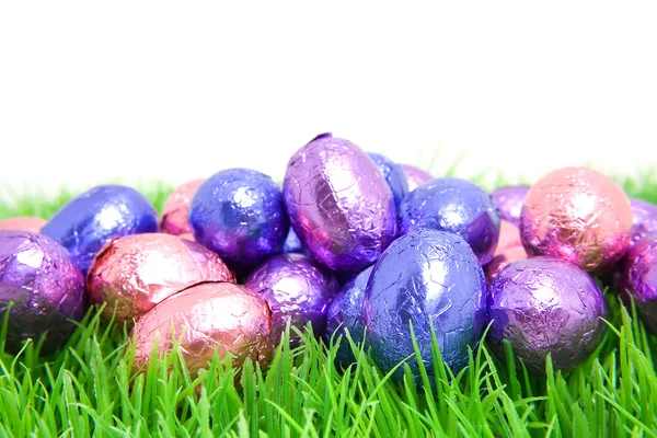 Colorful chocolate easter eggs in grass — Stok fotoğraf