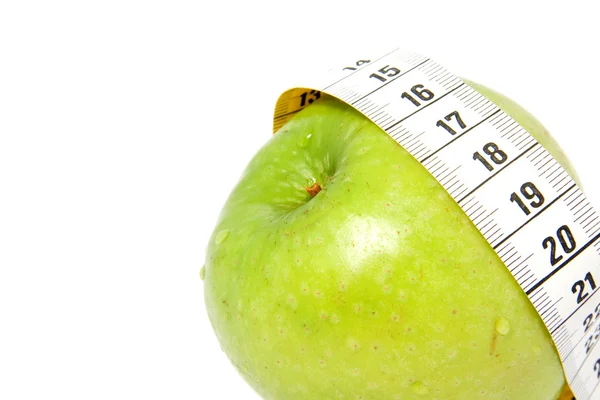 Zelené jablko s páskou opatření — Stock fotografie