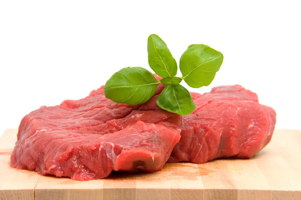 Raw steak on cutting board — Stock Photo, Image
