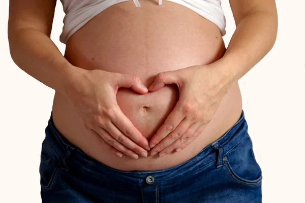 Pregnant belly with heart shape — Stock Photo, Image