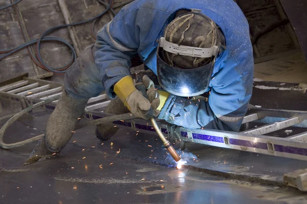 stock image The welder behind work