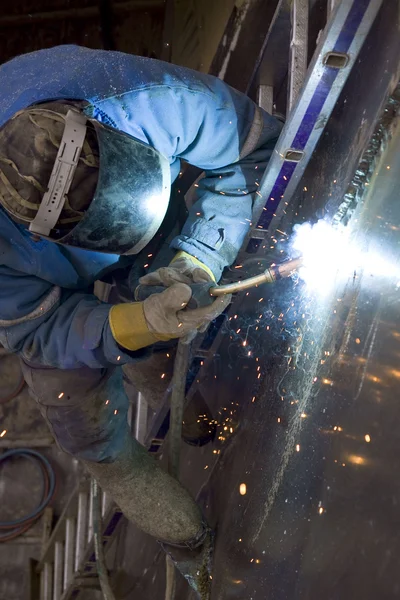 Stock image The welder behind work