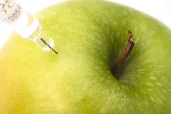 Green apple injected with chemicals — Stock Photo, Image