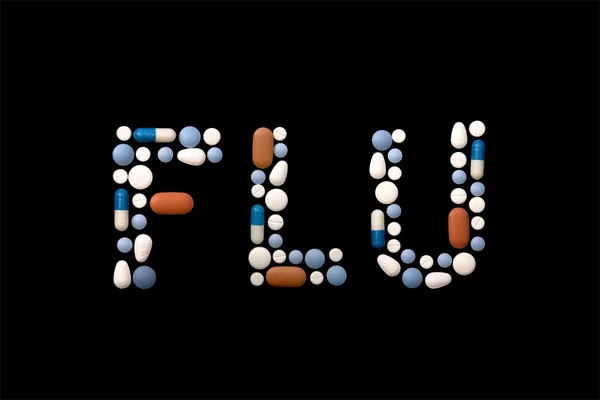 Grippe mot écrit avec des pilules — Photo