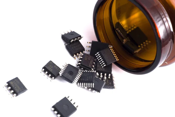 Brown bottle with scattered microchips — Stock Photo, Image