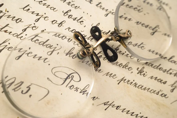 Very old glasses on open book — Stock Photo, Image