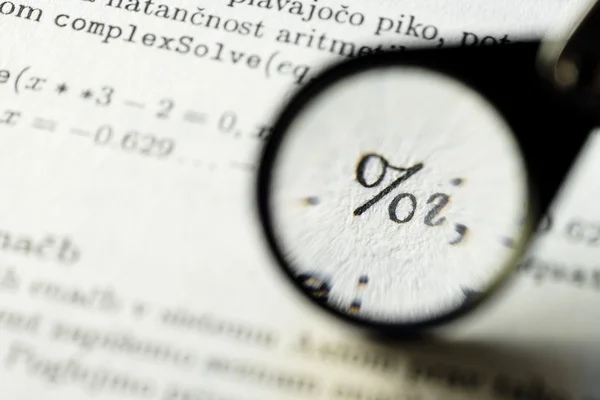 Math symbol magnified with loupe — Stock Photo, Image