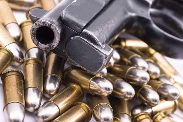 Pistol on pile of bullets — Stock Photo, Image