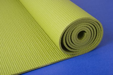 Green yoga mat on blue clipart