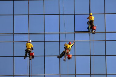 Men washing windows at height clipart