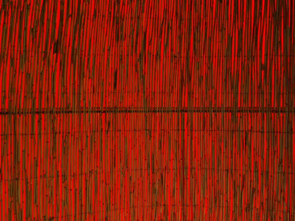 빨간 배경 가진 대나무 지팡이 벽 — 스톡 사진