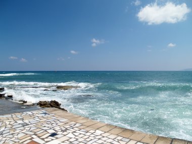 Stone paved walkway by the sea clipart