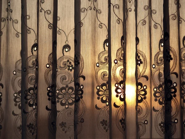 Sunset through window curtain — Stock Photo, Image