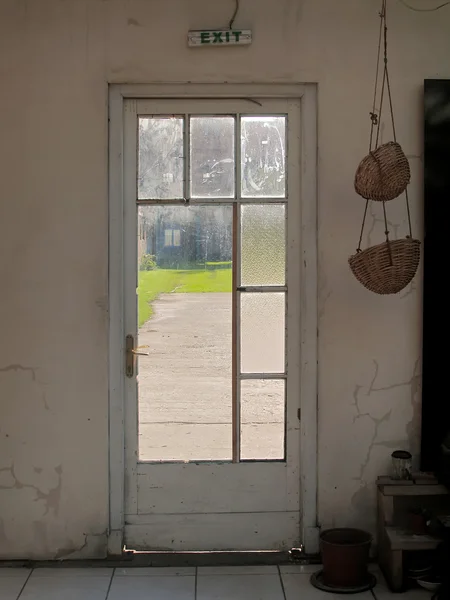 stock image Old glass door with exit sign above