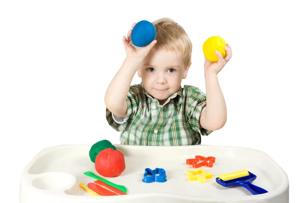 Happy child playing with plasticine — Stock Photo, Image