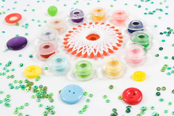 Sewqing bobbins, buttons, beads on white — Stock Photo, Image