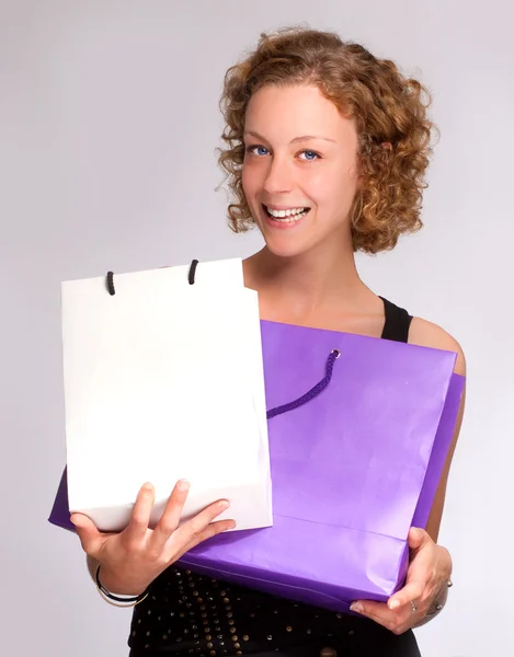 Girl showing her shopping — Stock Photo, Image