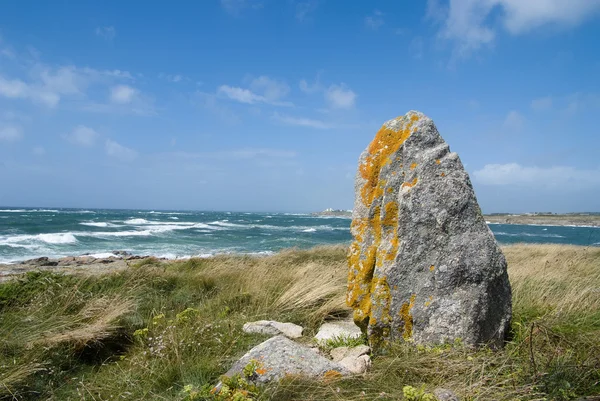 Ancient rock against a wild sea — Stock Photo, Image