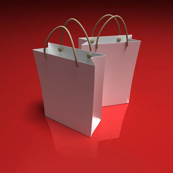 Par sacos de compras no fundo vermelho — Fotografia de Stock