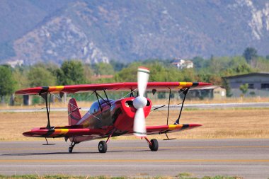 Red biplane taxying clipart