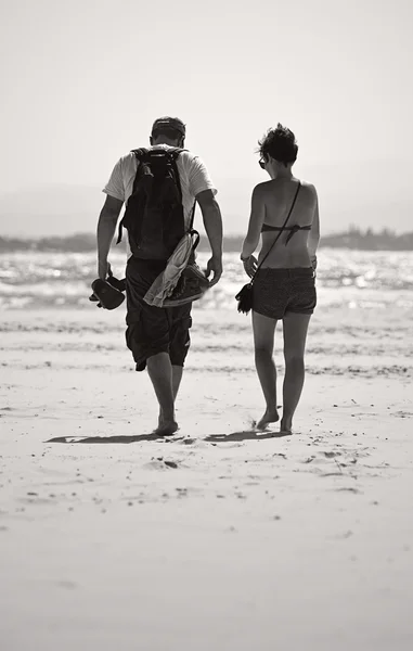 stock image Couple walking across beach