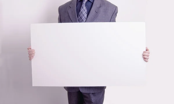 Businessman holding out a blank card — Stock Photo, Image