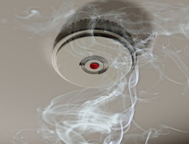 Smoke alarm in a smoky room clipart