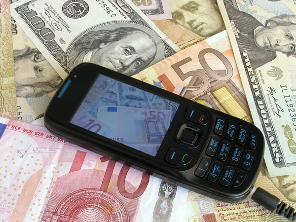 Mobile phone on banknotes — Stock Photo, Image