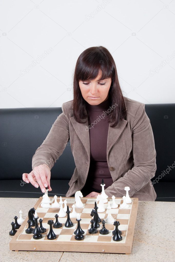 Businesswoman playing chess