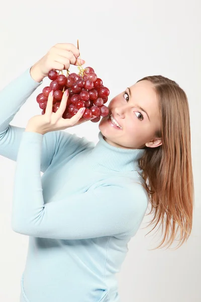 Woman tasting red grapes — Stock Photo, Image