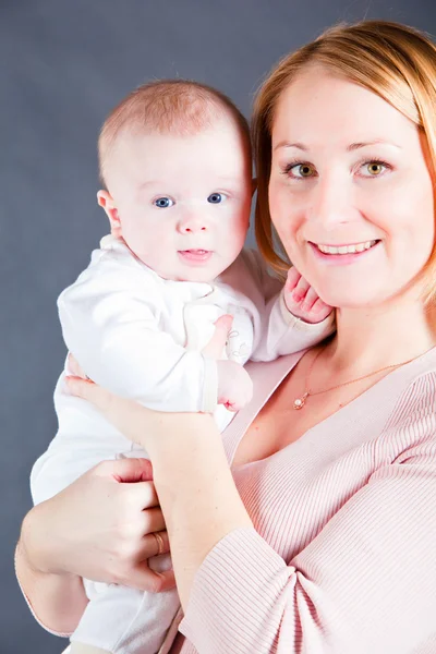 stock image Young mother holding baby boy