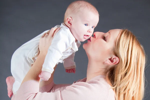 stock image Mother kissing baby boy