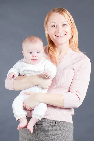 stock image Young mother holding baby boy