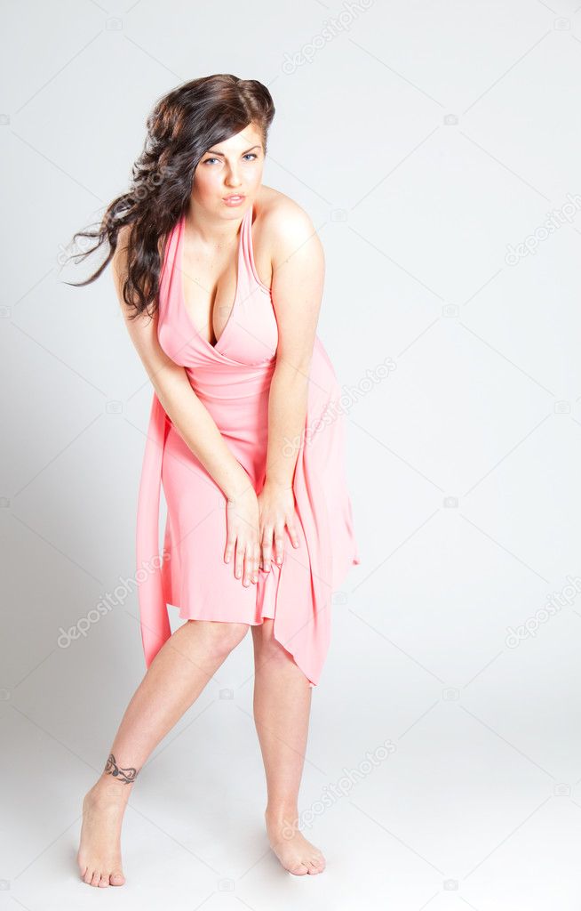 Sexy young woman in pink dress