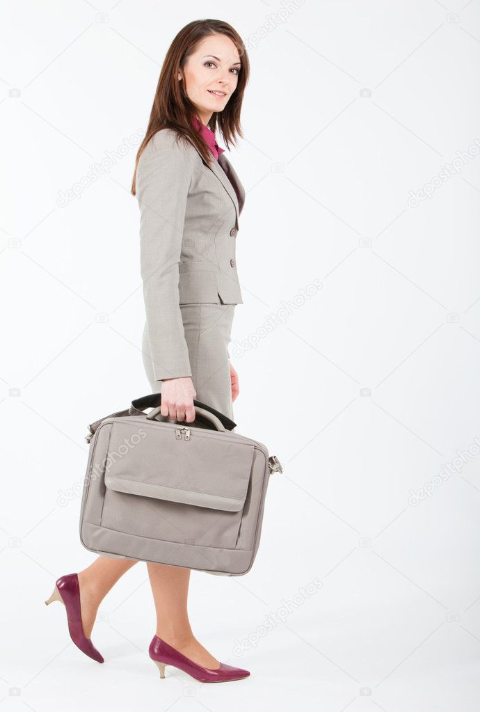 Business woman walking with case