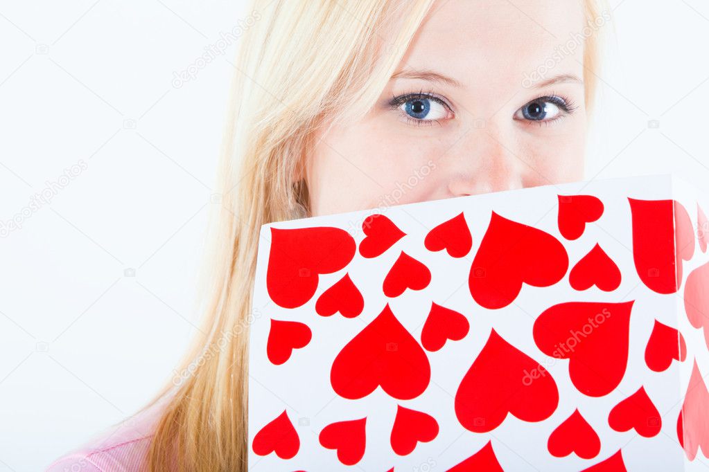 Young blond woman with valentine card