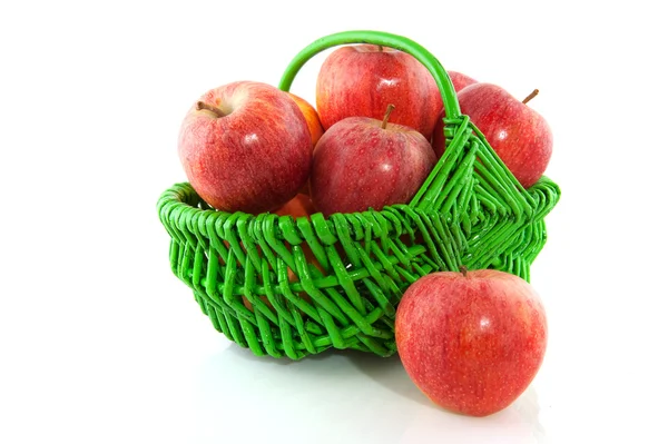 Apples in green basket — Stock Photo, Image