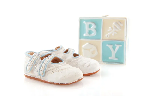 Baby shoes and piggy bank — Stock Photo, Image